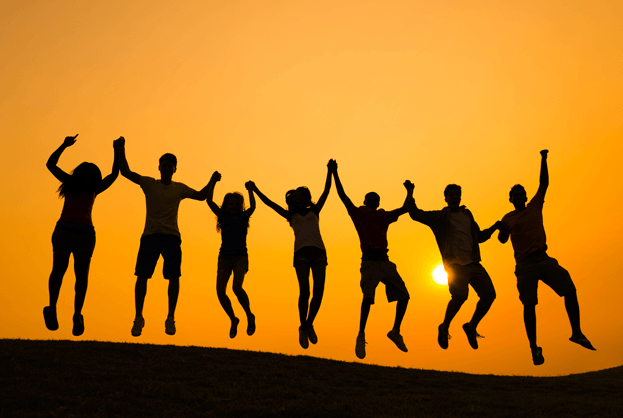 people jumping on a hill at sunrise