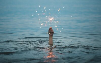 hand coming out of water holding sparkler
