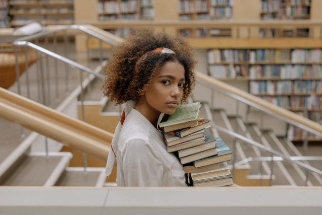 woman carrying books