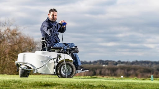kris aves on electric disabled buggy on a golf course